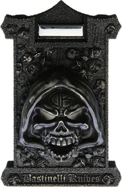 A bronze sculpted cigar cutter with a detailed skull design, featuring stainless cutters and a zippered storage case.