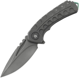 A folded knife with a gray titanium handle and a stonewash finish blade, featuring a green pocket clip and black nylon storage case.