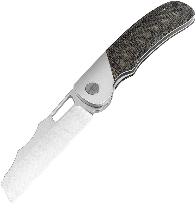 A black folding knife with a satin finish blade, titanium bolster, and black canvas micarta handle, featuring a thumb pull and a lanyard hole.