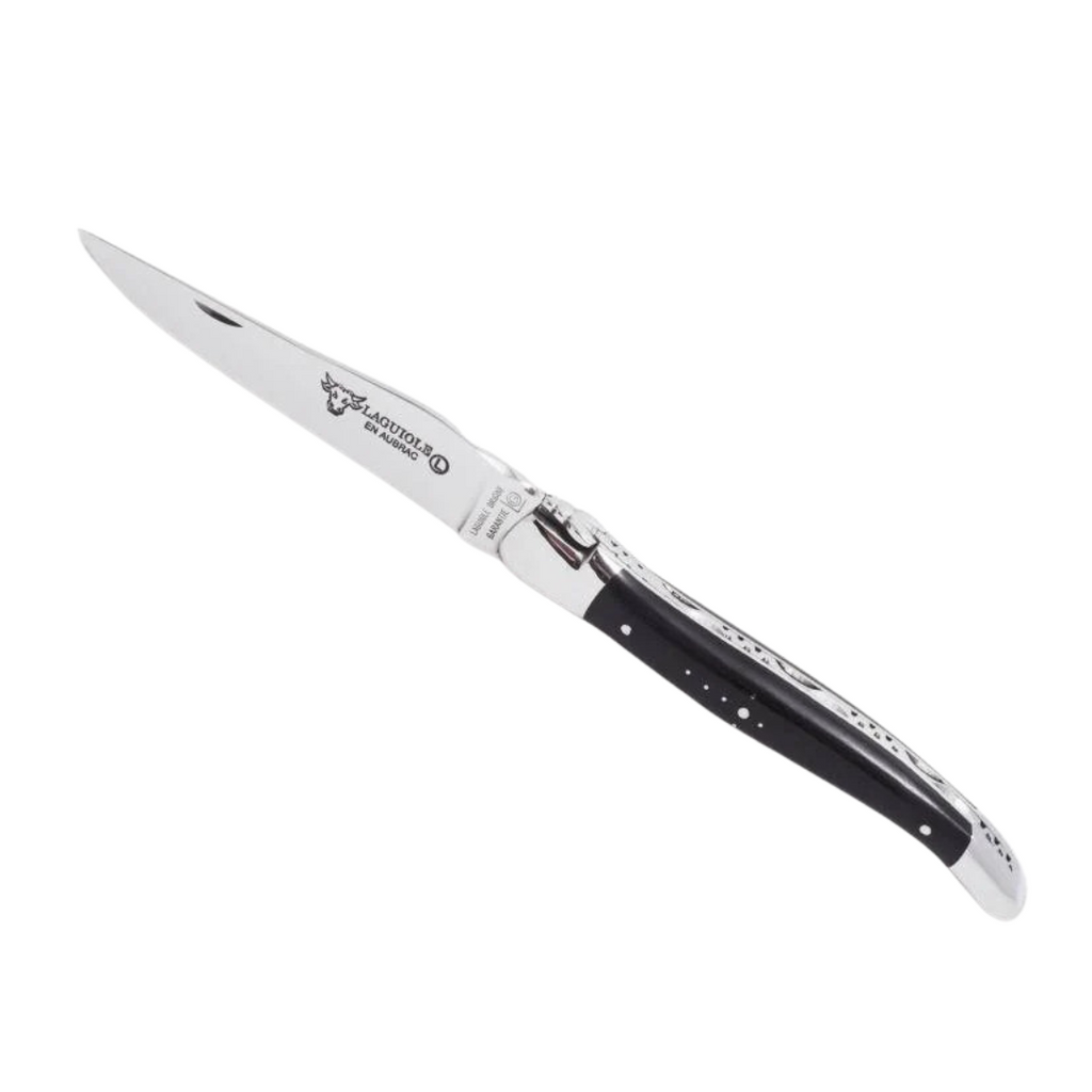 Laguiole En Aubrac Folding Pocket Knife (12cm) with Ebony Wood Handle. This traditional French pocket knife features a stainless steel blade and a shepherd's cross emblem on the handle.