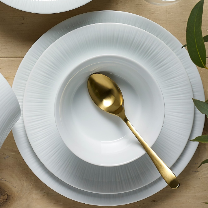 Noritake Conifere Plates and Bowls in various sizes, white, gold spoon on top of a stack