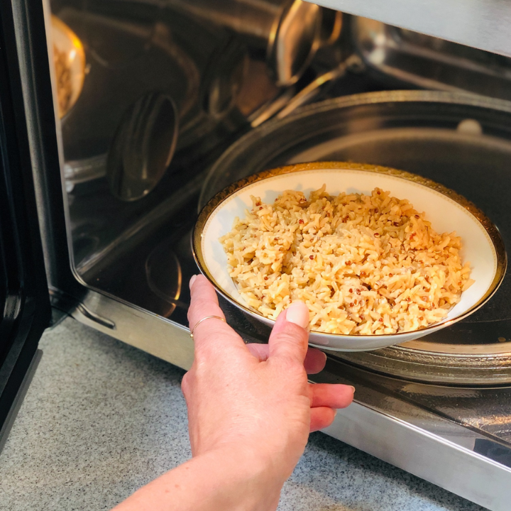 Noritake Charlotta Gold Fine Porcelain Bowl, gold-rimmed, placed inside a microwave oven