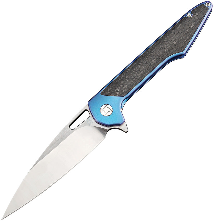 A folding knife with a blue anodized titanium handle and carbon fiber inlay, satin finish blade, thumb pull, pocket clip, extended tang, and metal tin. | King of Knives e-store