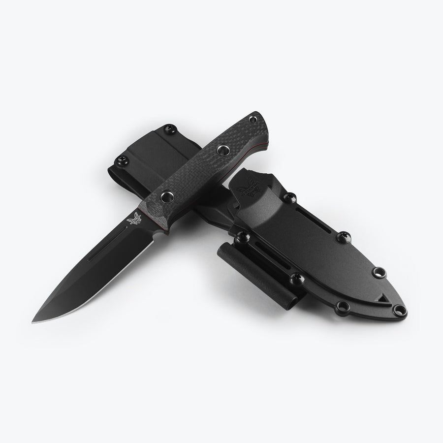 A Benchmade 163BK Bushcrafter fixed blade knife with a black handle and blade, displayed with its open blade and modular sheath.