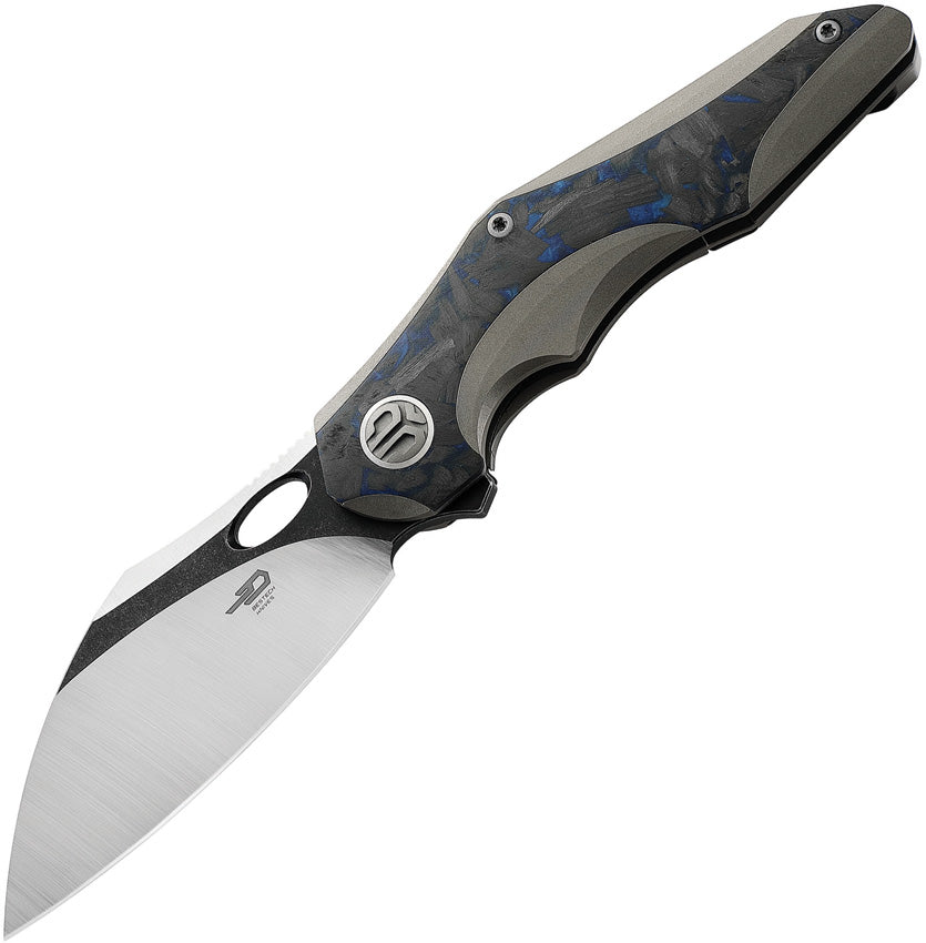 A folded pocket knife with a black stonewash and satin finish blade, gray titanium handle with black and blue marble carbon fiber inlay, and a thumb pull. The knife is partially open, displaying the blade and the handle.