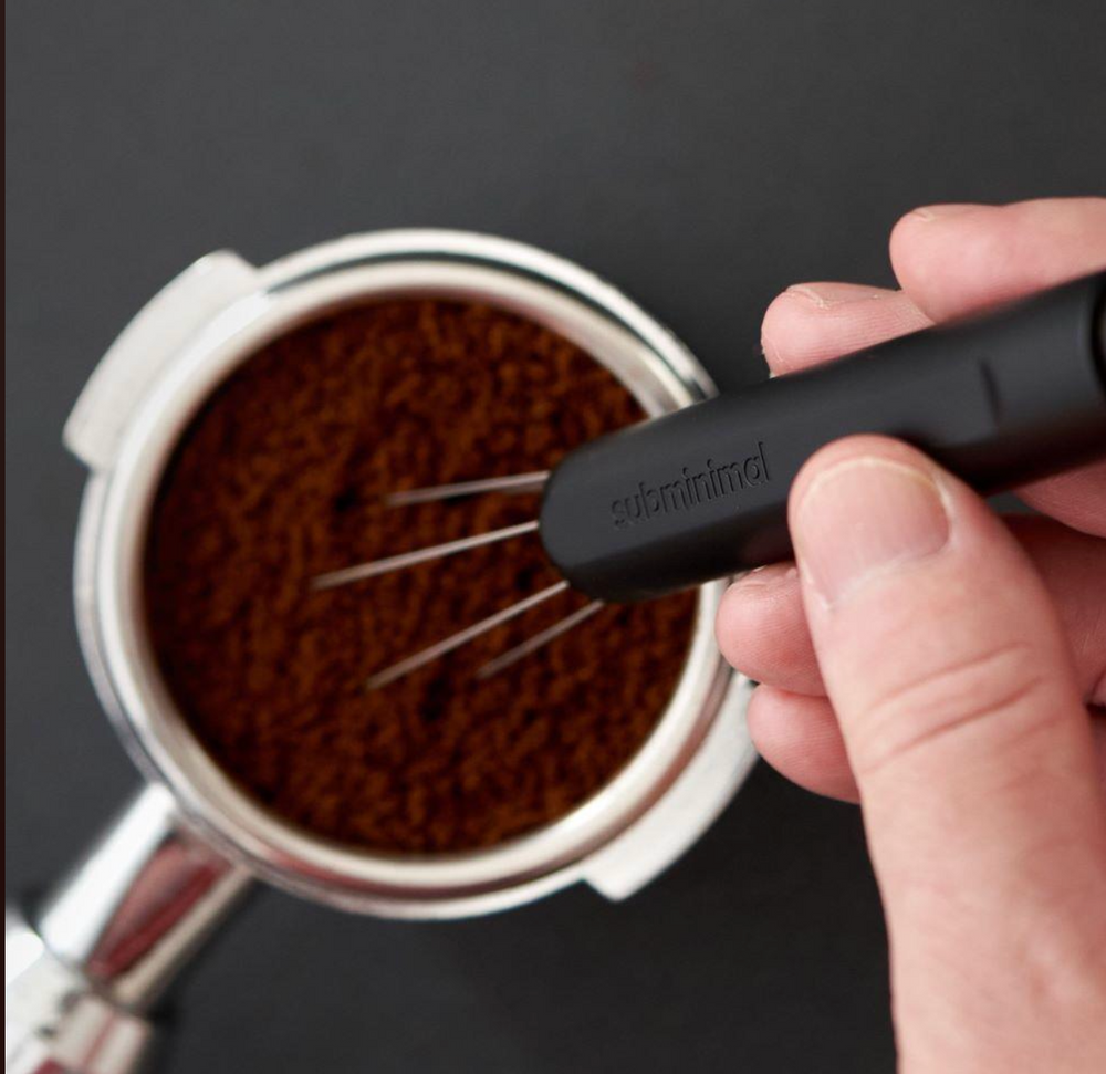 Subminimal Flick WDT Pen distributing coffee grounds