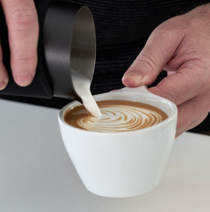 Subminimal Flow Tip handleless black 450ml jug in use for making coffee