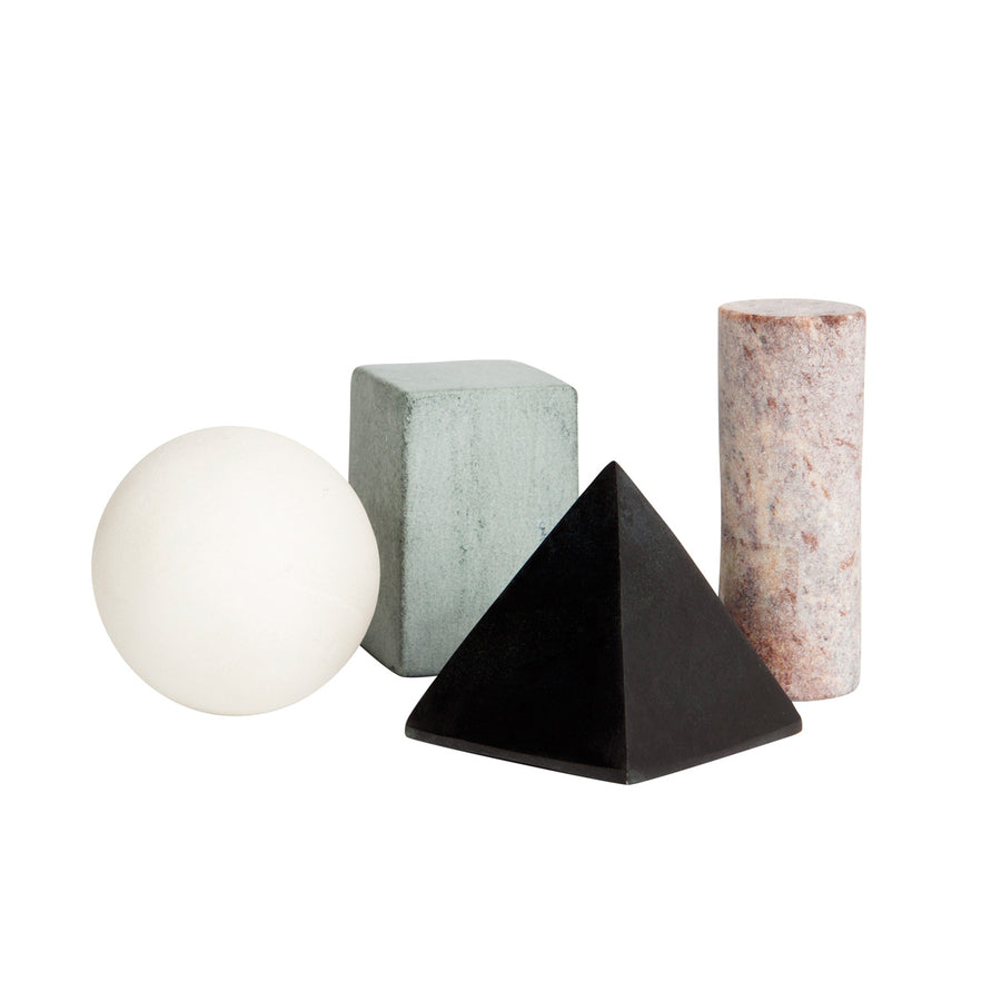 An assortment of geometric-shaped drink rocks, including a sphere, a triangular prism, a tetrahedron, and a roundish object, all in varying colors and textures.