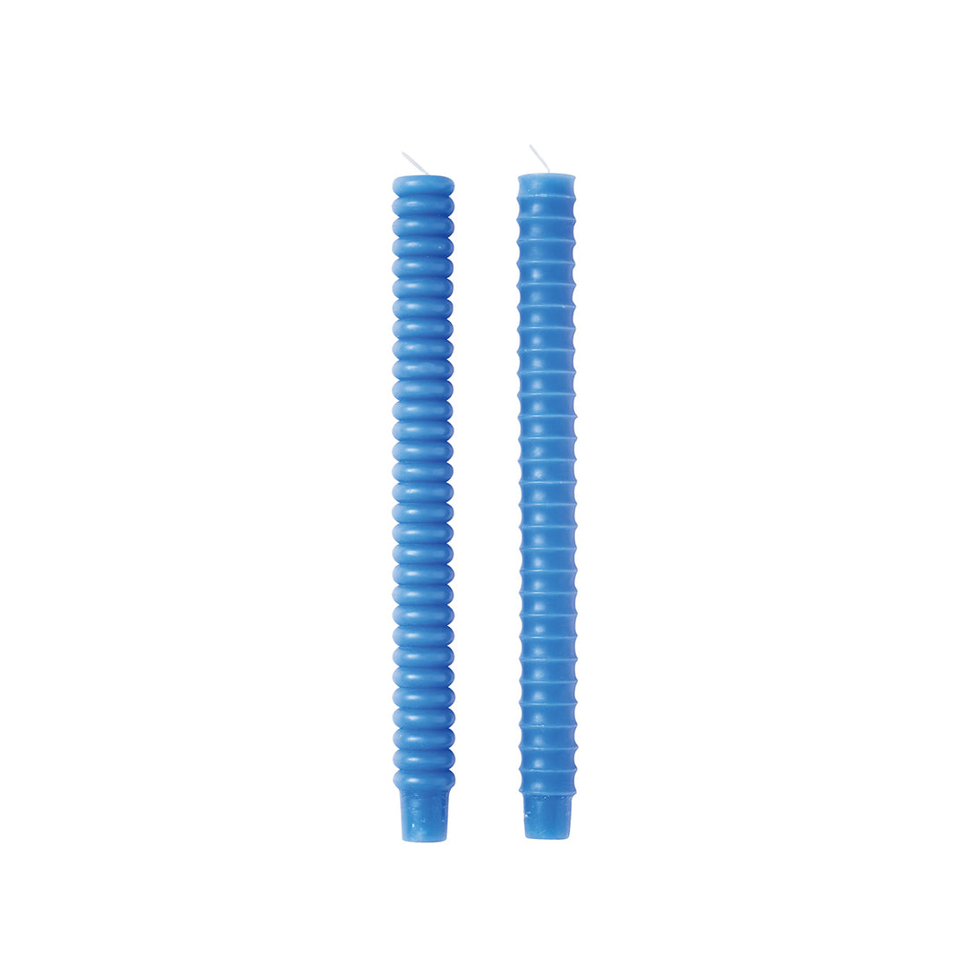 Two blue taper candles with a smooth finish and distinctive, curved design, displayed against a white background.