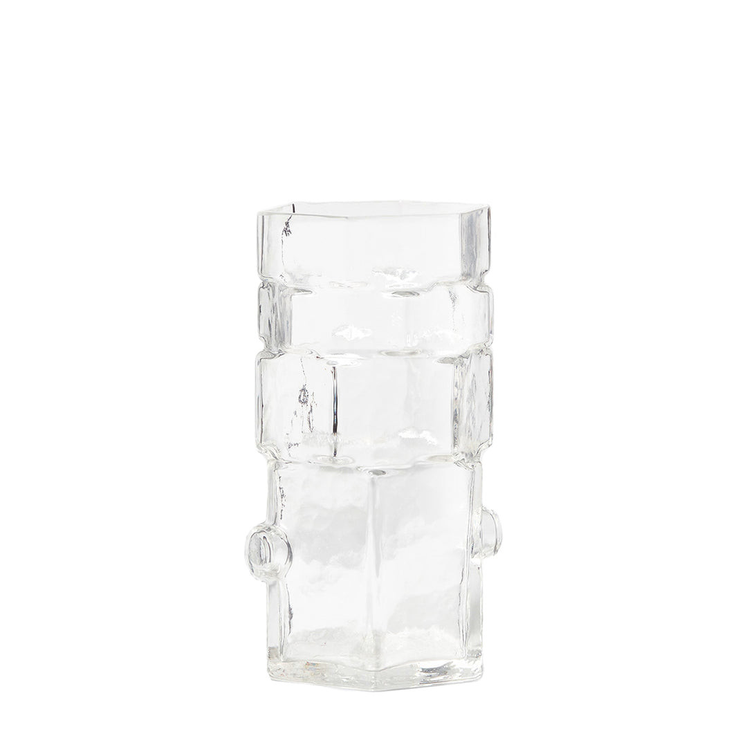 A clear geometric glass vase with stacked hexagonal shapes.
