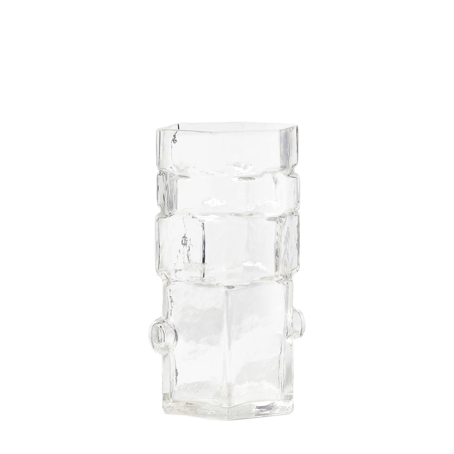 A clear geometric glass vase with stacked hexagonal shapes.