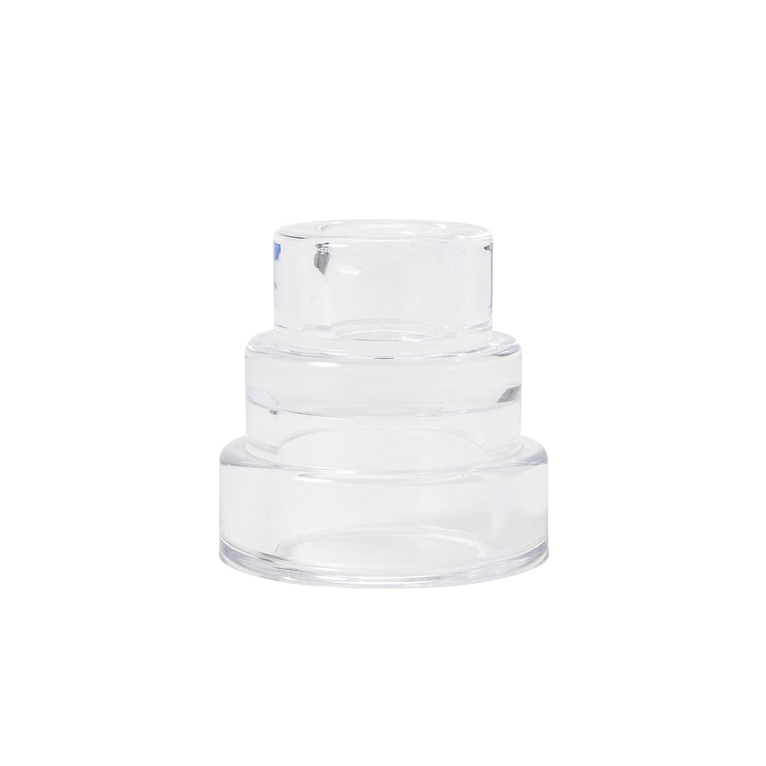 A clear glass candle holder with a layered design resembling terraced hillsides.