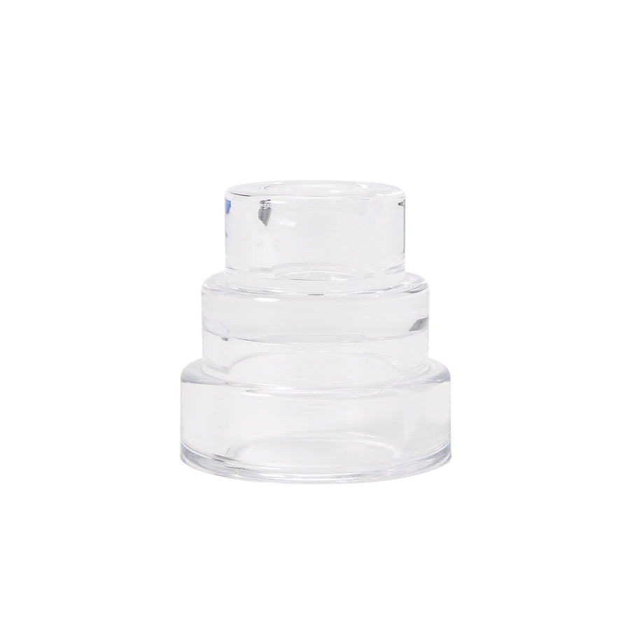 A clear glass candle holder with a layered design resembling terraced hillsides.