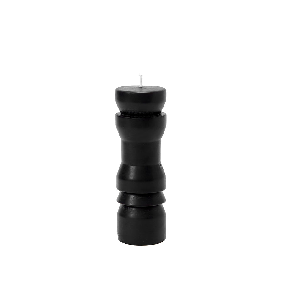 A black, medium-sized totem candle with a smooth finish and a natural, mottled appearance, designed by Grain for Areaware.