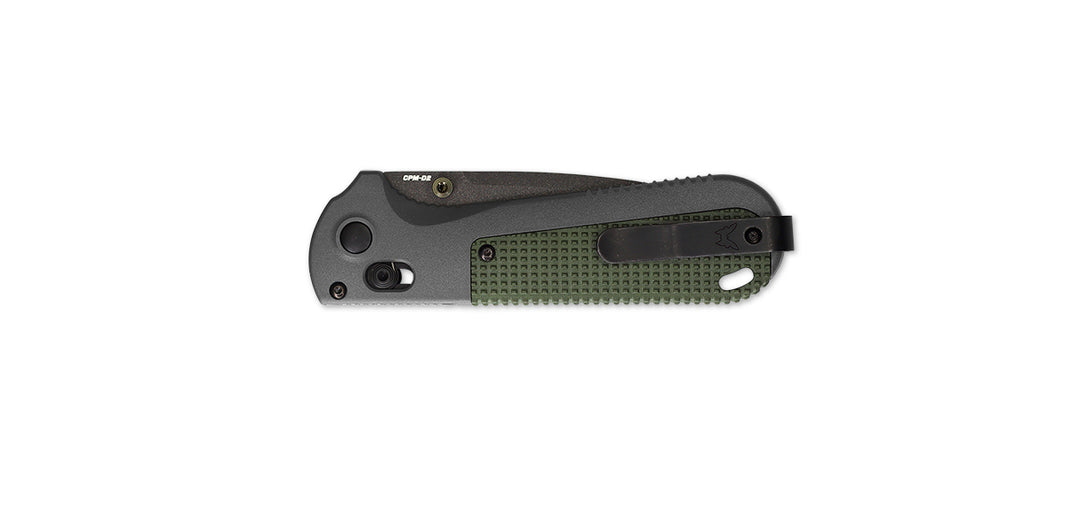 A Benchmade folding knife with a serrated edge and a green handle.