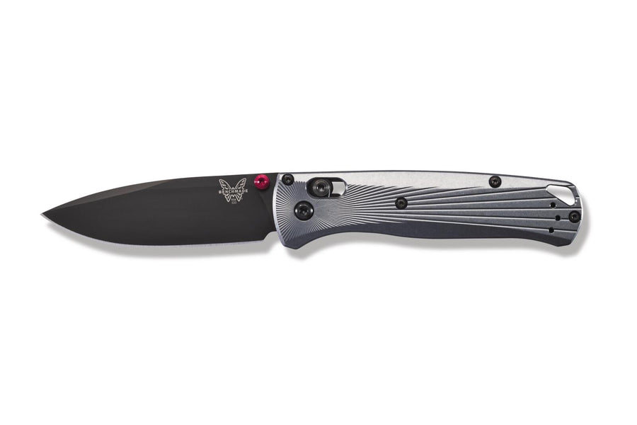 A folding knife with a black handle and a metallic blade, featuring red anodised barrel spacers and a drop point blade design.