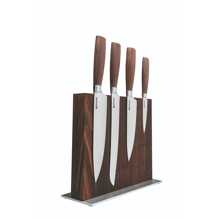 A set of four walnut handled knives with stainless steel blades, displayed in a walnut knife block with a polished finish.