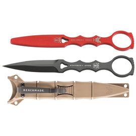 A set of three fixed blade knives from Benchmade, featuring a black dagger design with red and grey sheaths and a sand-colored trainer.